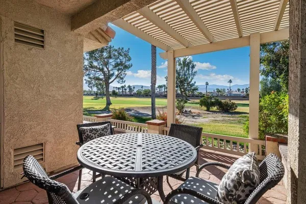 a view of a chairs and table in patio