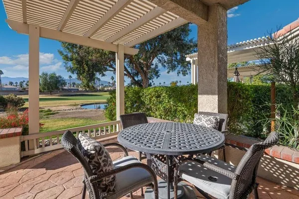 a view of a patio with a table chairs and a table