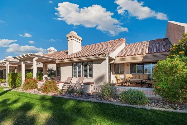 a front view of a house with a garden and plants