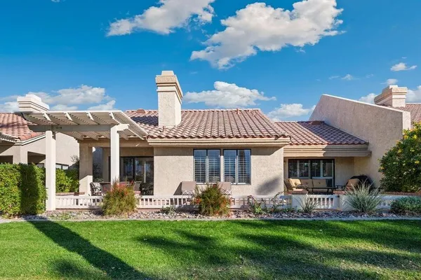 a front view of a house with a garden and plants
