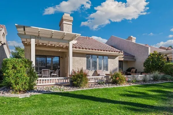 a front view of a house with a garden and plants