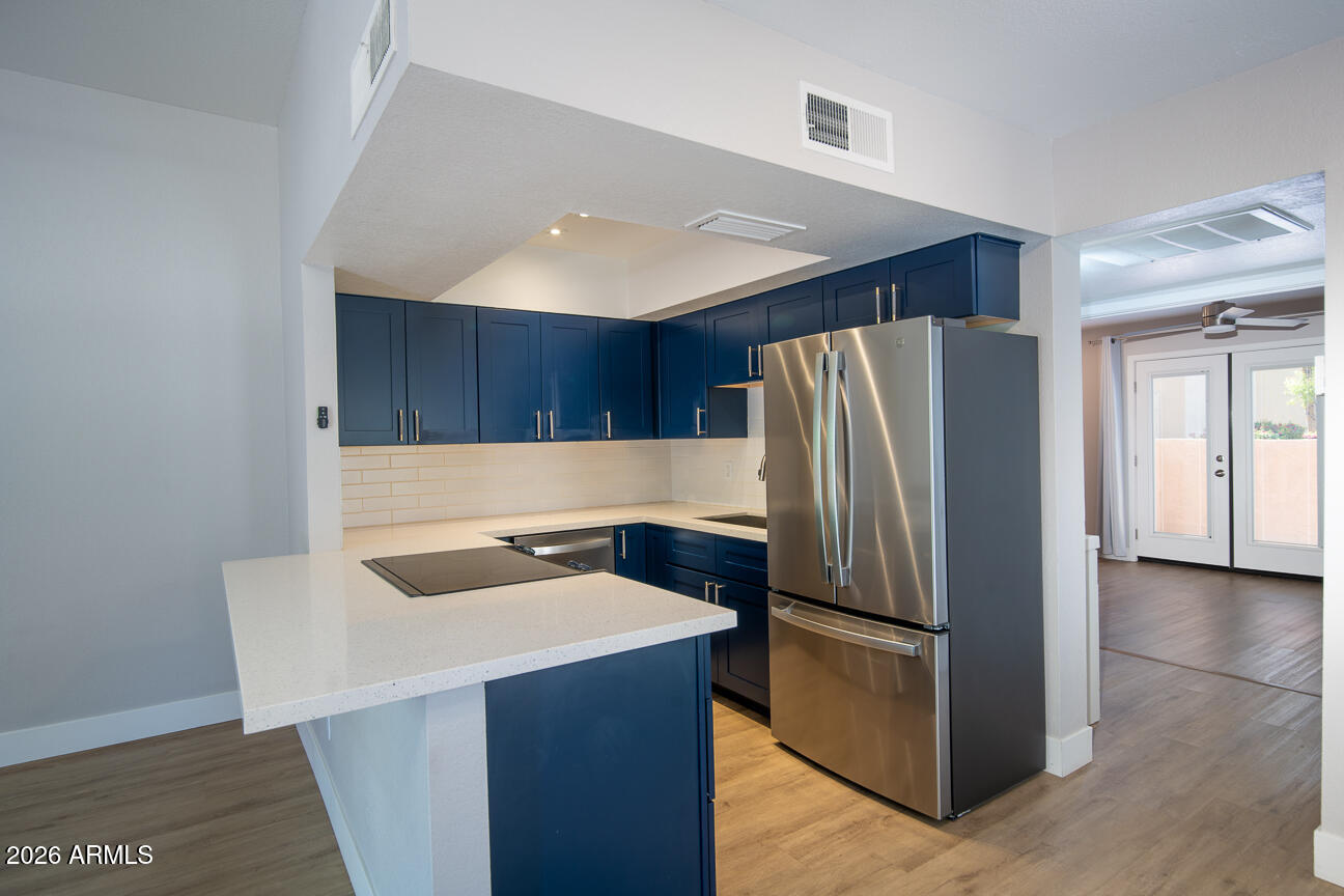 4540 North 44th Street, Unit 50 Phoenix, AZ 85018 - Photo 2 of 31 a kitchen with granite countertop a refrigerator and a sink
