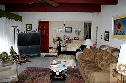 71425 Halgar Road Rancho Mirage, CA 92270 - Photo 9 of 13 a living room with furniture and a flat screen tv