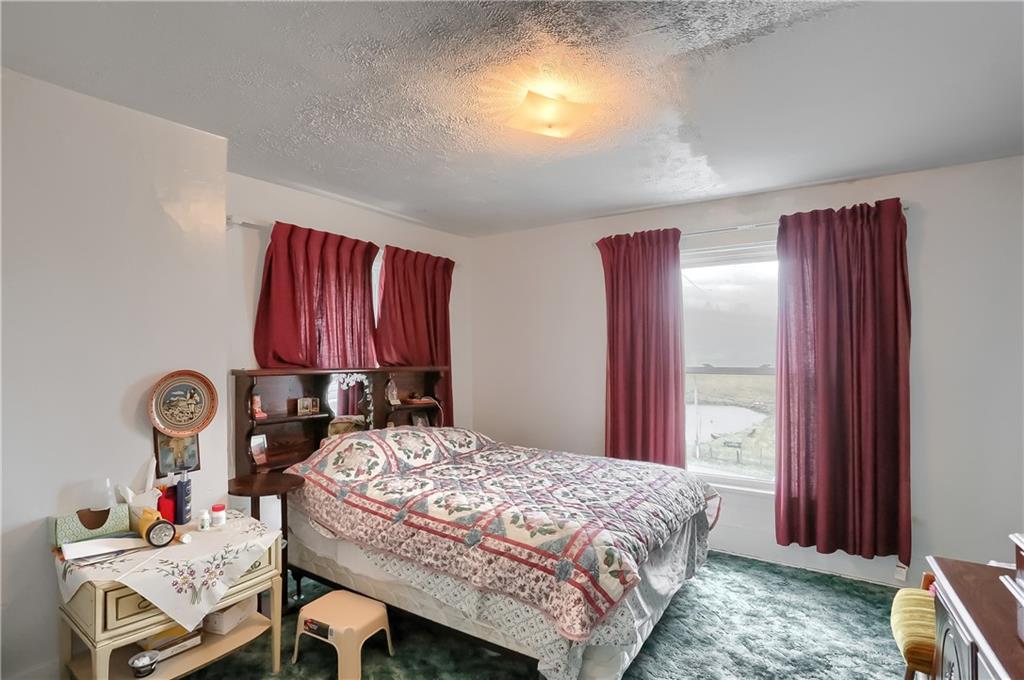 191 Pyle Road Jefferson, PA 15344 - Photo 17 of 24 a bed sitting in a bedroom next to a window