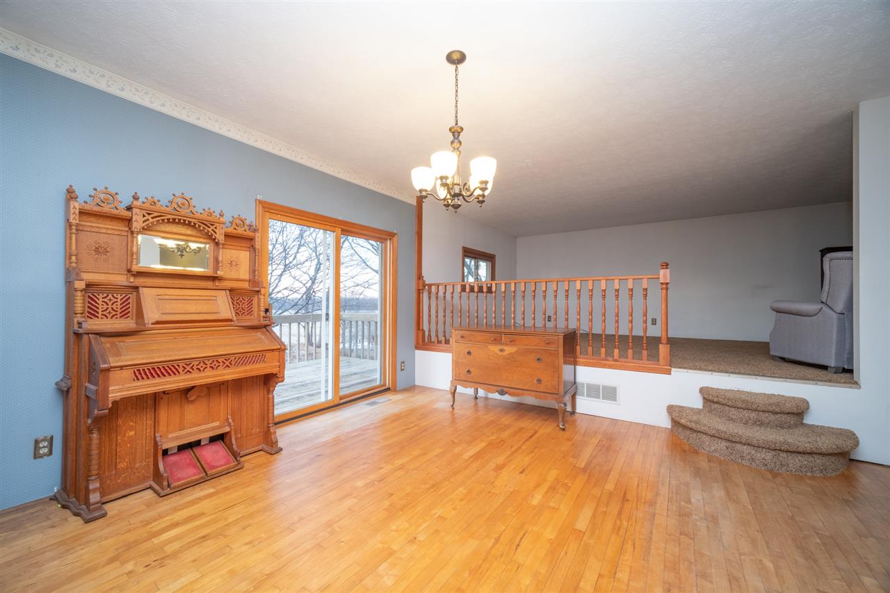 4202 Baxter Road Rockford, IL 61109 - Photo 8 of 26 a living room with furniture and a chandelier