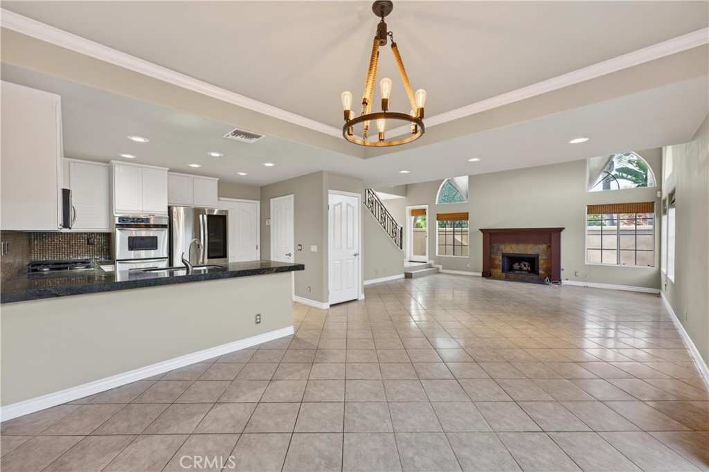 152 Terraza Court Costa Mesa, CA 92627 - Photo 15 of 47 a view of a kitchen with a sink and a chandelier