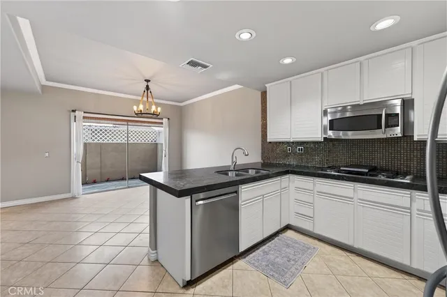 a kitchen with stainless steel appliances granite countertop a sink and a stove