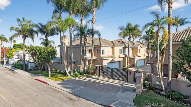 a view of a palm trees front of house