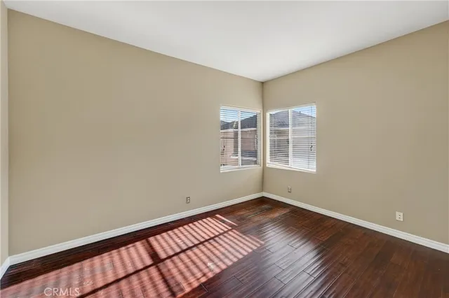 a view of a room with wooden floor and windows