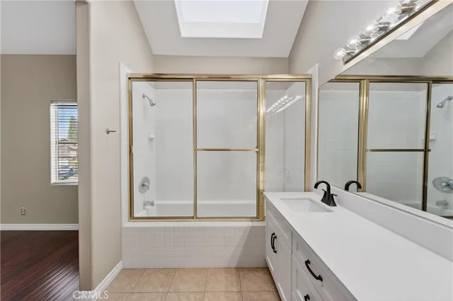 a bathroom with a tub sink and mirror