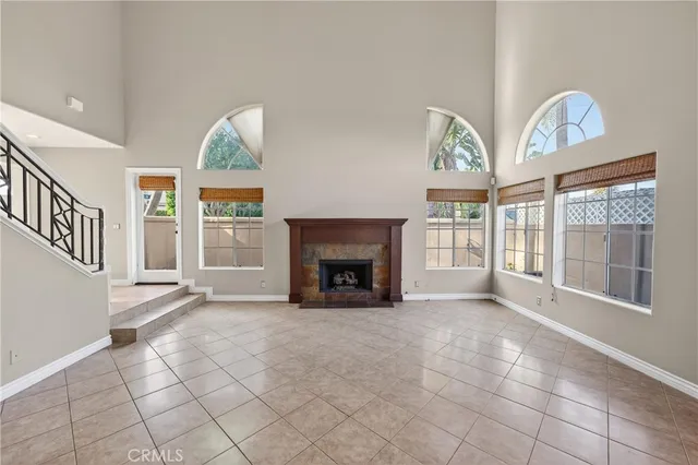 a view of an empty room with a fireplace and a window