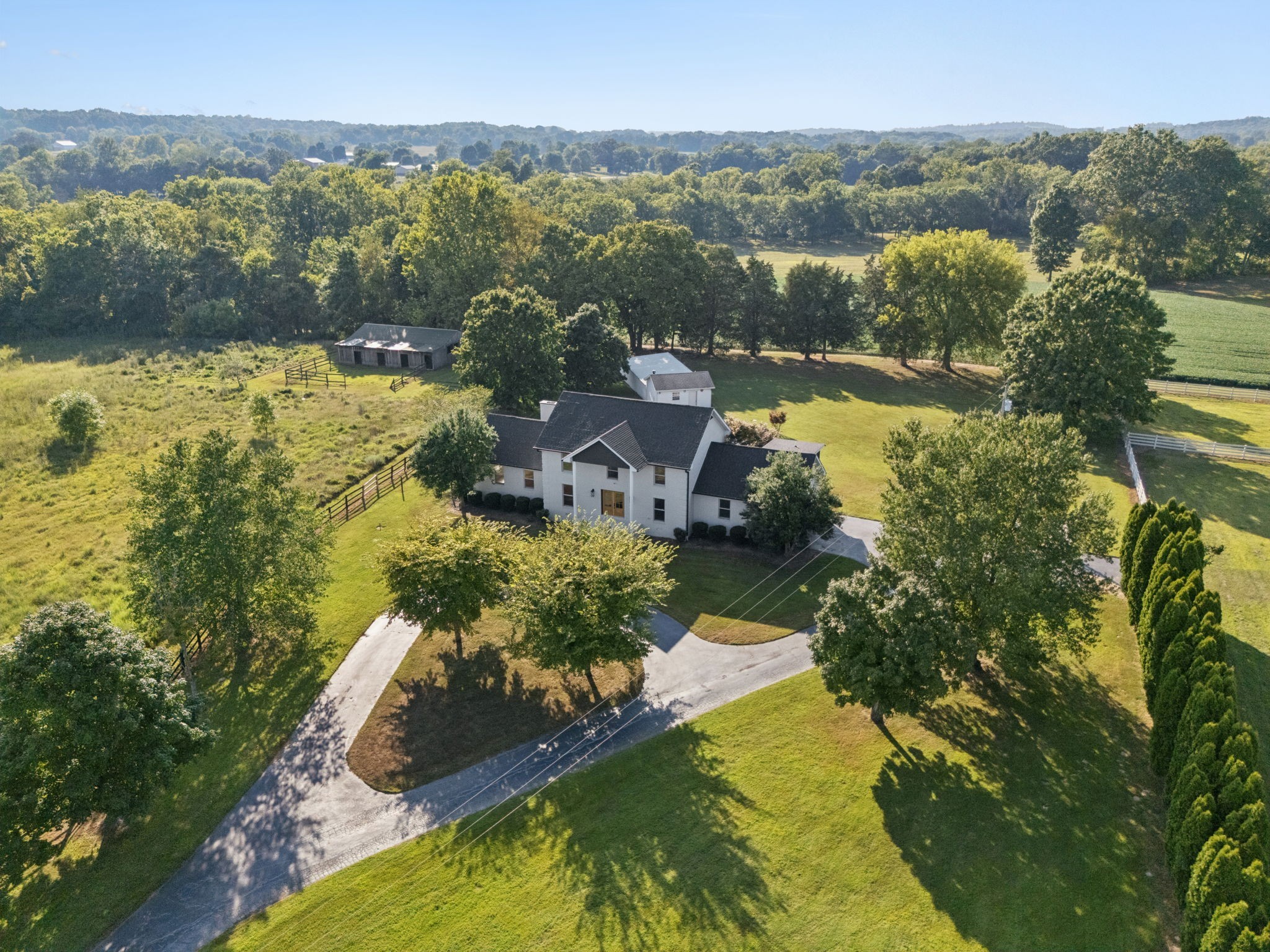 an aerial view of residential houses with outdoor space and lake view