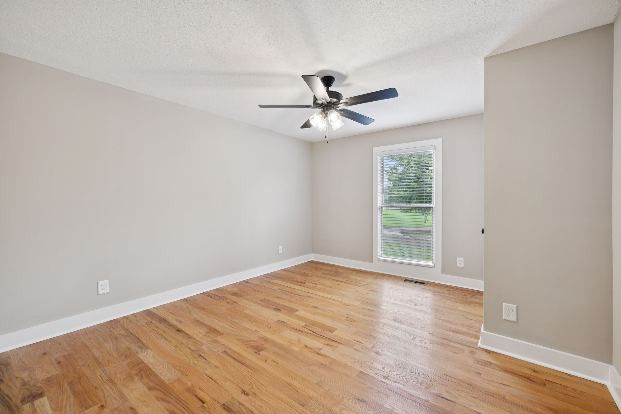 3935 Harmony Grove Road Hopkinsville, KY 42240 - Photo 19 of 64 a view of empty room with wooden floor and fan