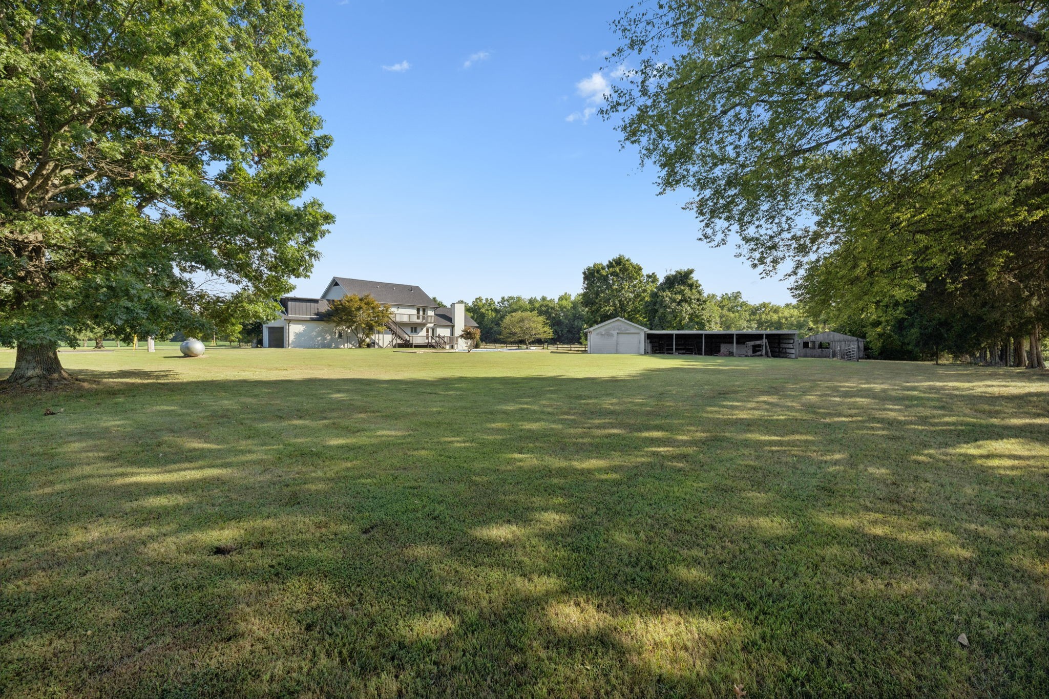 3935 Harmony Grove Road Hopkinsville, KY 42240 - Photo 55 of 64 a backyard of a house with lots of green space