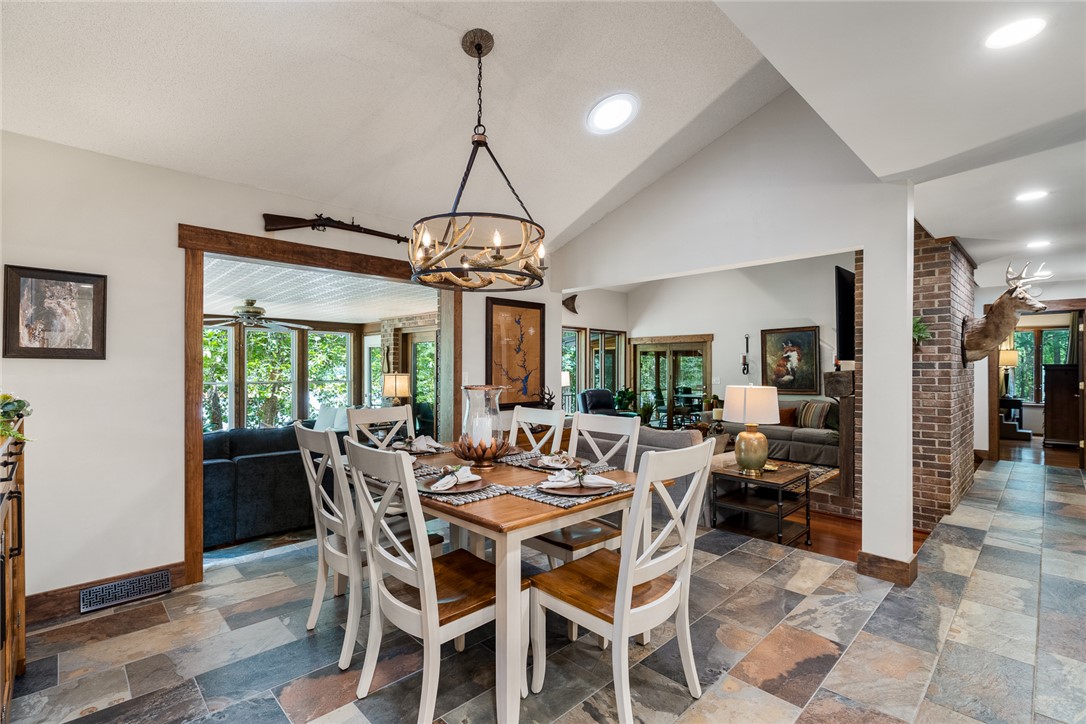 2817 Providence Church Road Anderson, SC 29626 - Photo 8 of 35 Durable tile flooring extends through this open concept dining area, illuminated by a distinctive antler chandelier and recessed lighting.