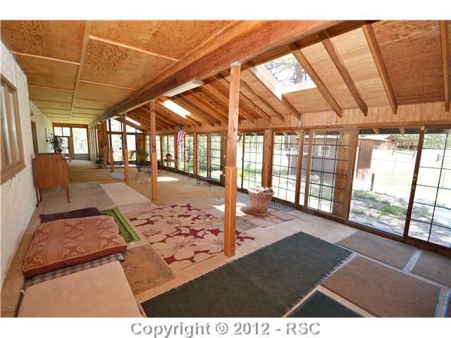 11685 Howells Road Colorado Springs, CO 80908 - Photo 13 of 16 1200 SQ FT COVERED & ENCLOSED PATIO LOCATED ON THE BACK OF THE HOME.