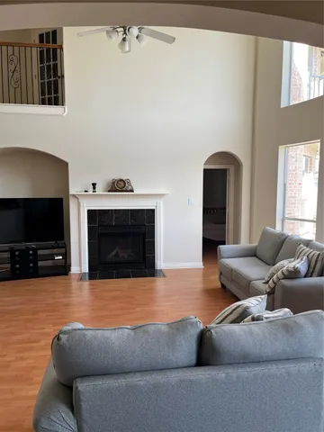 a living room with furniture a fireplace and a flat screen tv