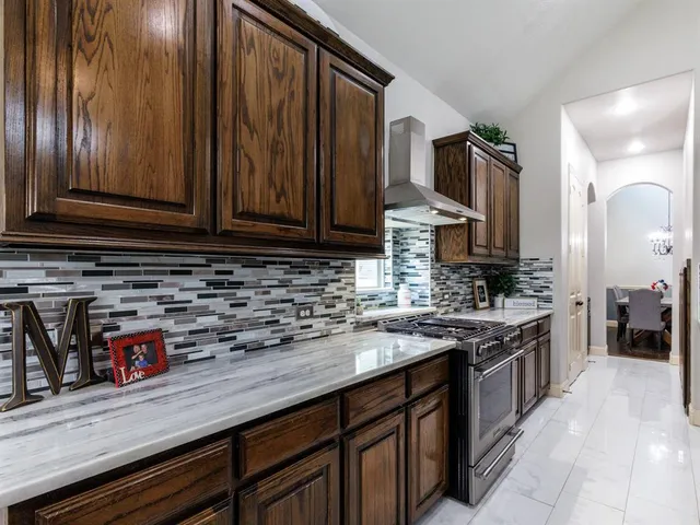 a kitchen with stainless steel appliances granite countertop a sink stove and cabinets