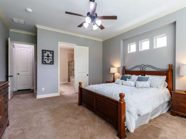 a bedroom with a bed and a chandelier