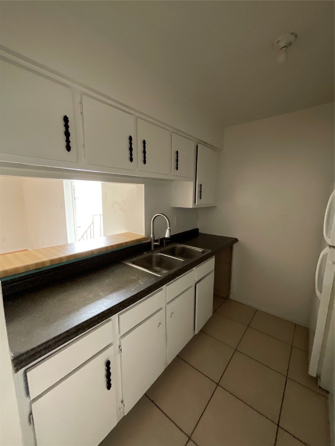 6161 Reims Road, Unit 1305 Houston, TX 77036 - Photo 12 of 28 a kitchen with granite countertop a sink a stove and cabinets