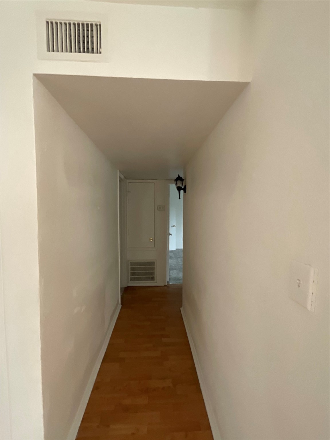 6161 Reims Road, Unit 1305 Houston, TX 77036 - Photo 14 of 28 a view of a hallway with wooden floor