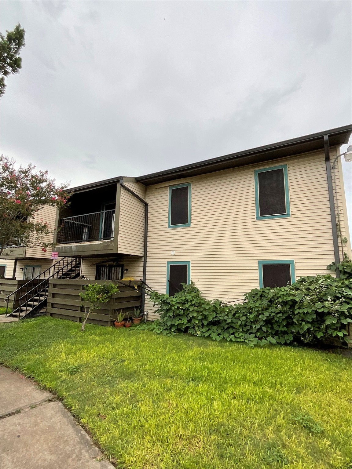 6161 Reims Road, Unit 1305 Houston, TX 77036 - Photo 2 of 28 a front view of a house with a yard