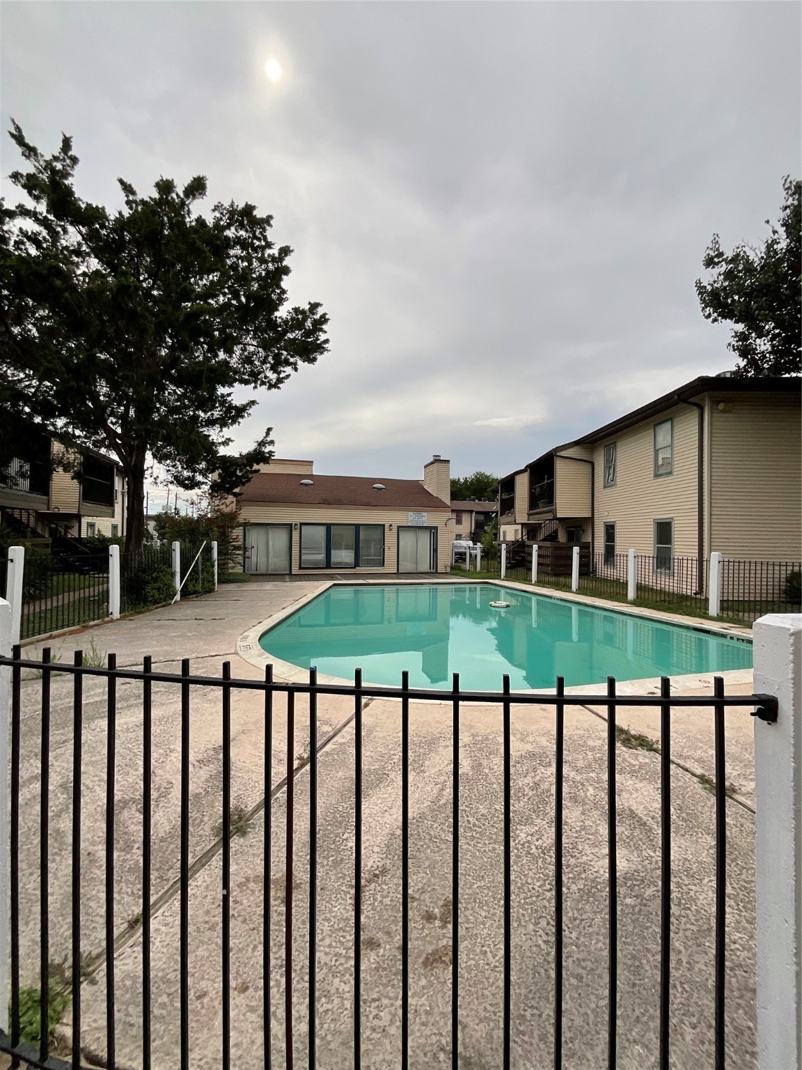 6161 Reims Road, Unit 1305 Houston, TX 77036 - Photo 27 of 28 a view of a white house with a big yard and potted plants