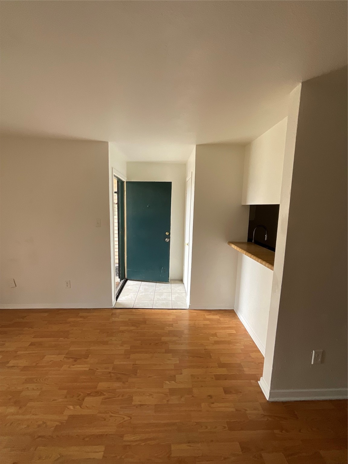 6161 Reims Road, Unit 1305 Houston, TX 77036 - Photo 5 of 28 a view of an empty room with wooden floor and a window