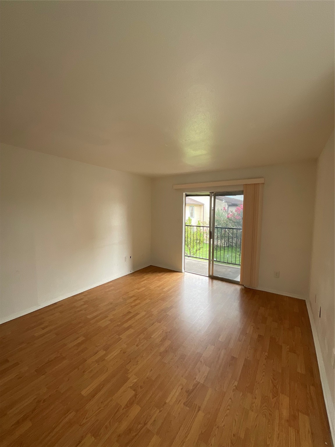 6161 Reims Road, Unit 1305 Houston, TX 77036 - Photo 6 of 28 a view of an empty room with wooden floor and a window