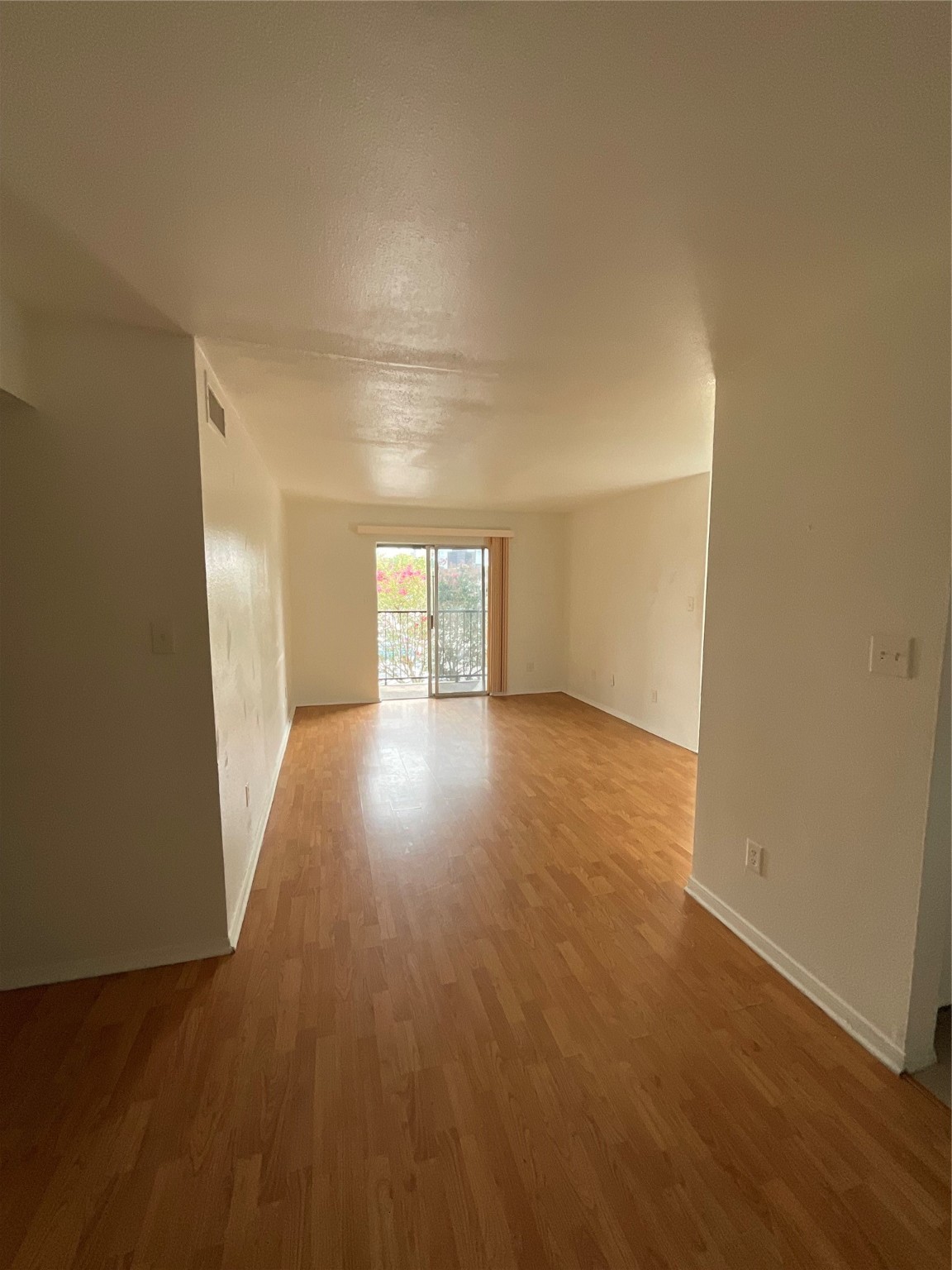 6161 Reims Road, Unit 1305 Houston, TX 77036 - Photo 7 of 28 an empty room with wooden floor and windows