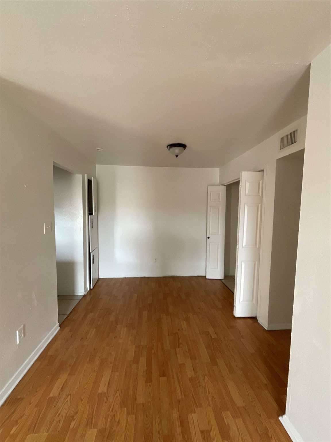 6161 Reims Road, Unit 1305 Houston, TX 77036 - Photo 9 of 28 a view of empty room with wooden floor