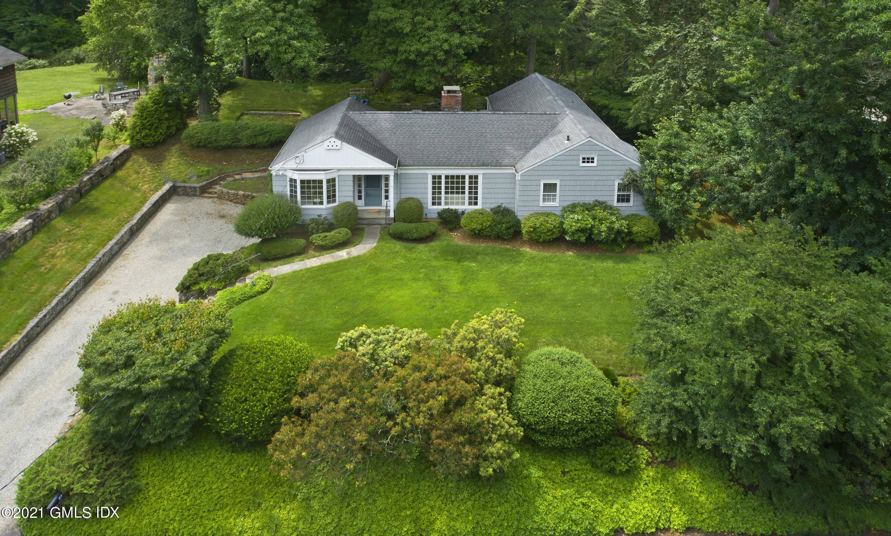 a aerial view of a house with yard and green space