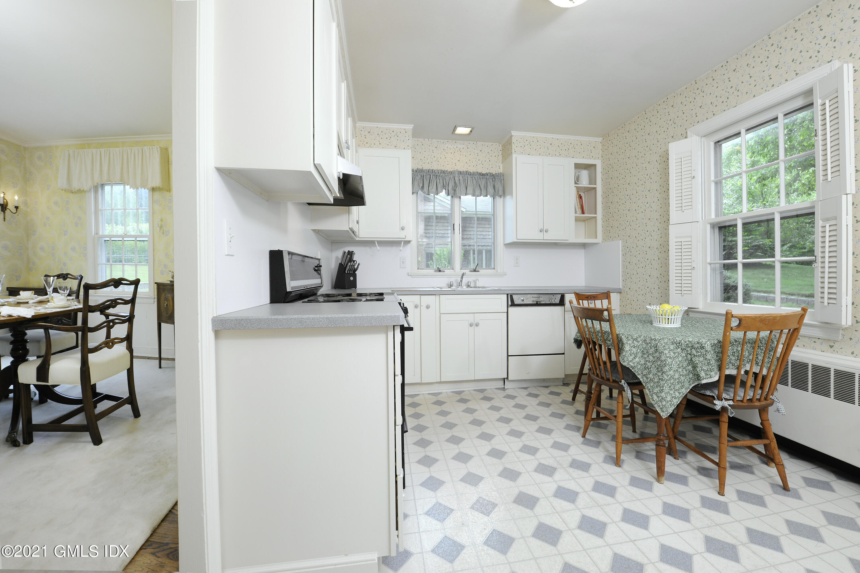 64 Hillside Road Greenwich, CT 06830 - Photo 12 of 24 a kitchen with a dining table chairs and large window