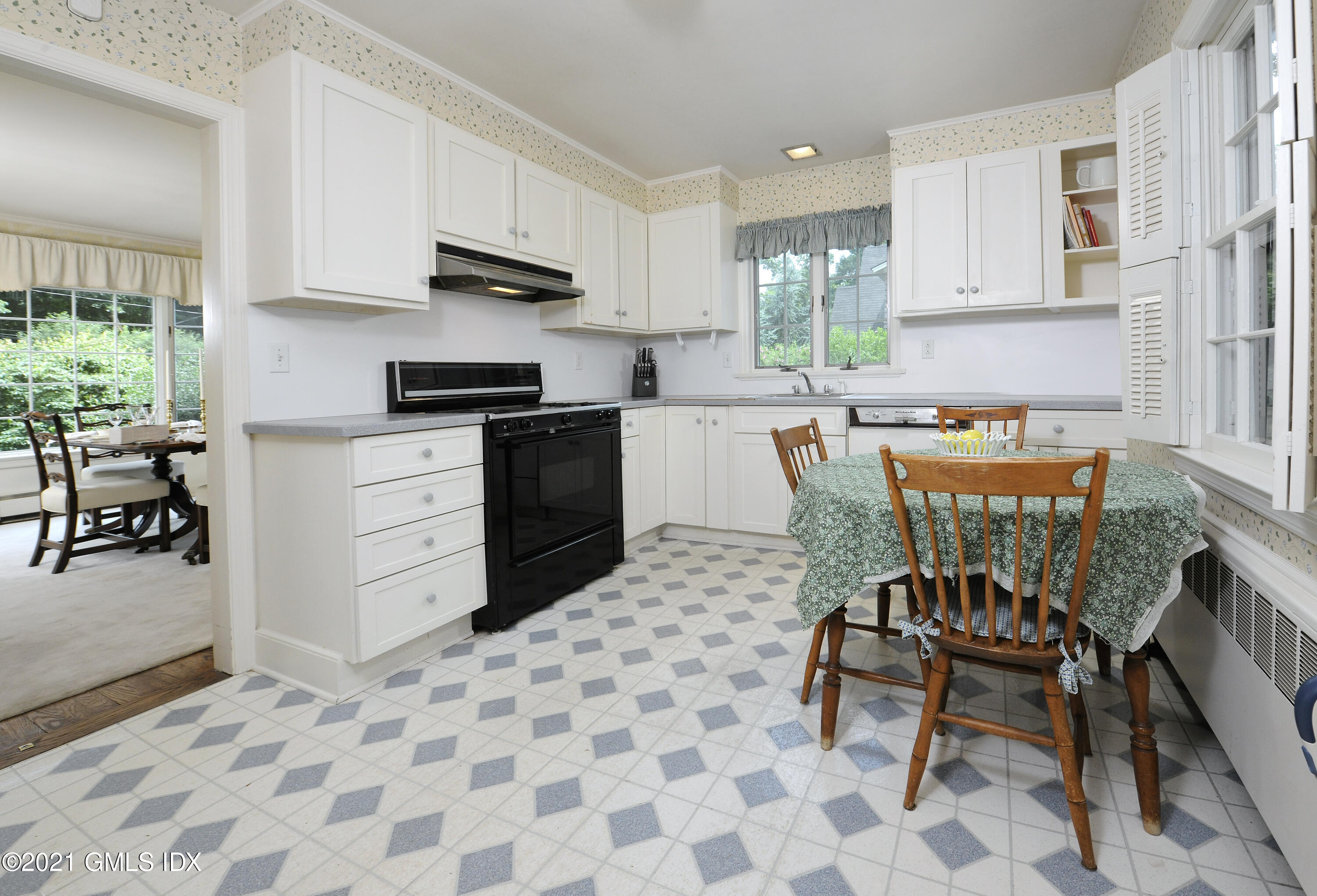 64 Hillside Road Greenwich, CT 06830 - Photo 13 of 24 a kitchen with stainless steel appliances granite countertop a stove top oven a sink a dining table and chairs