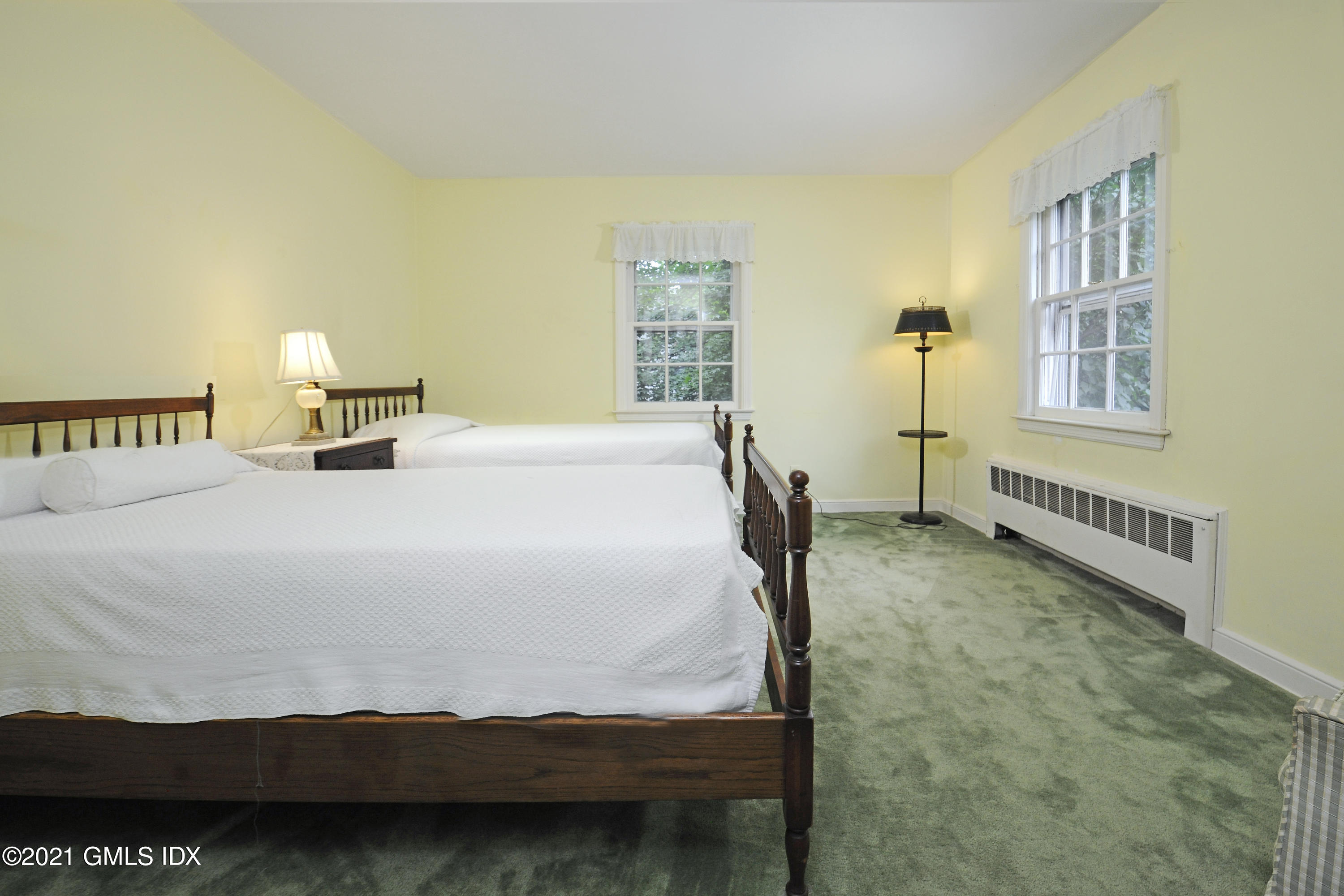 64 Hillside Road Greenwich, CT 06830 - Photo 17 of 24 a bedroom with a bed and a window