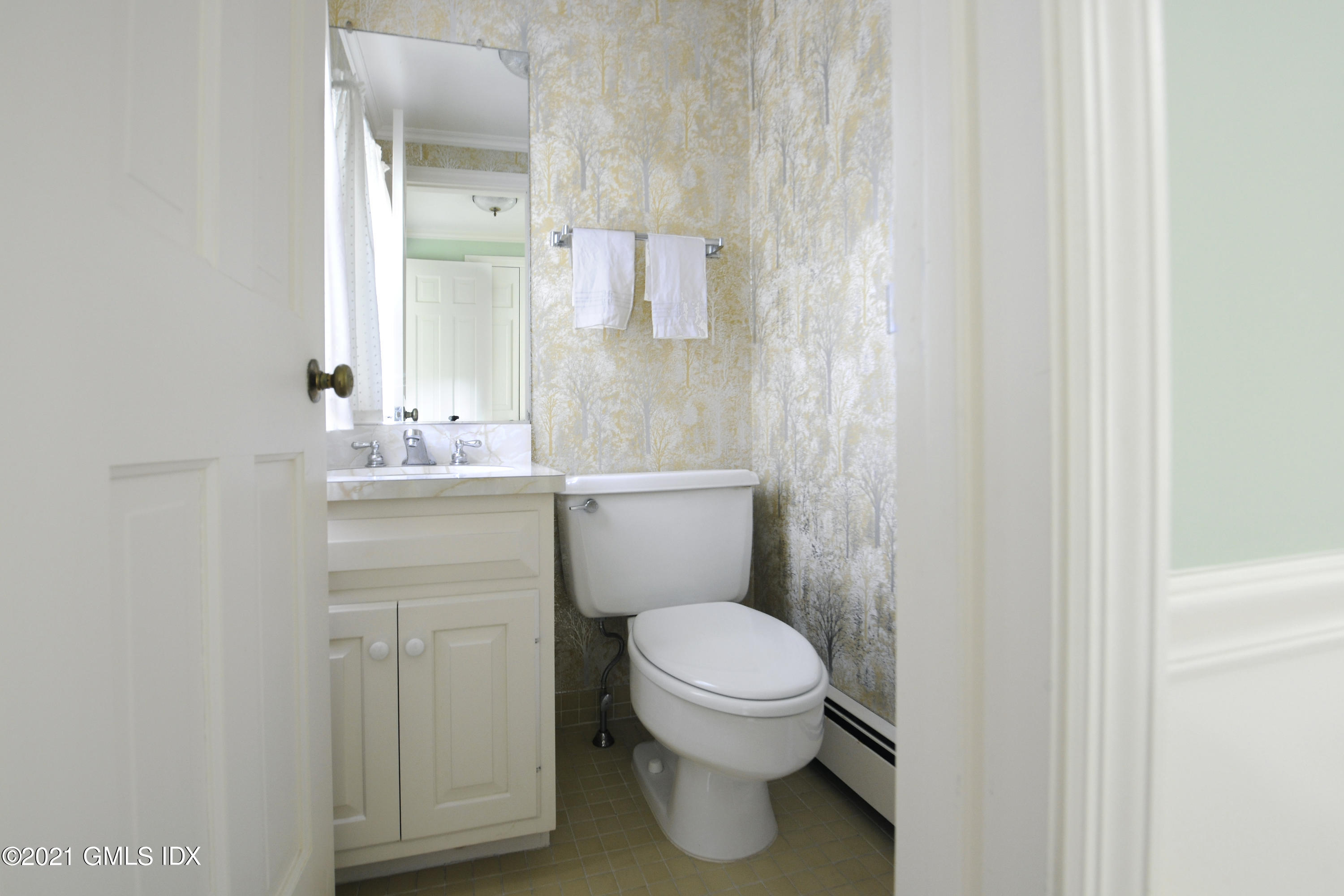 64 Hillside Road Greenwich, CT 06830 - Photo 18 of 24 a bathroom with a toilet a sink and mirror