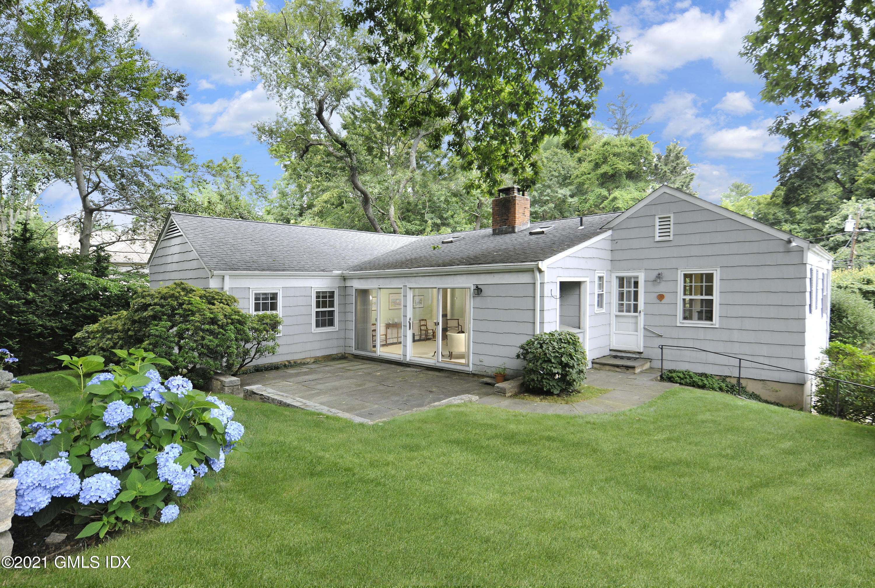 64 Hillside Road Greenwich, CT 06830 - Photo 19 of 24 a front view of a house with a garden