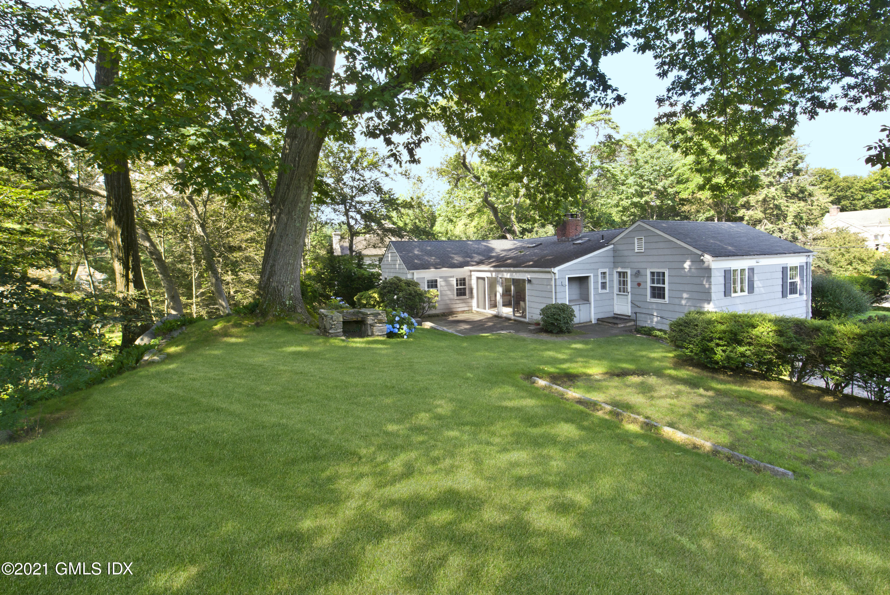 64 Hillside Road Greenwich, CT 06830 - Photo 20 of 24 a front view of a house with garden