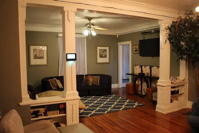 a bedroom with furniture and wooden floor