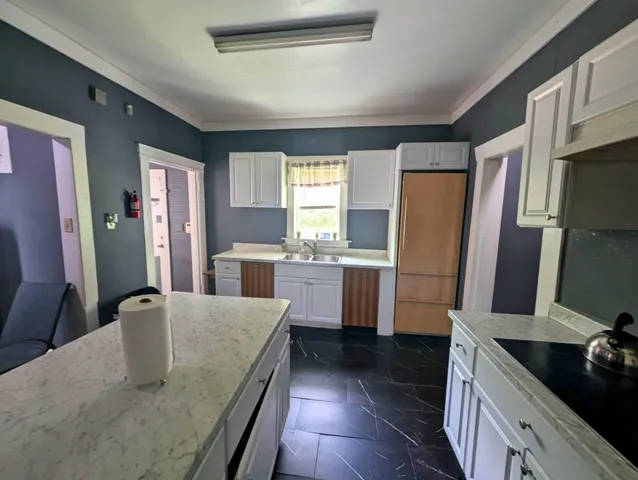 a kitchen with a sink a microwave a stove and refrigerator