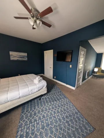 a view of a livingroom with a chair and a window
