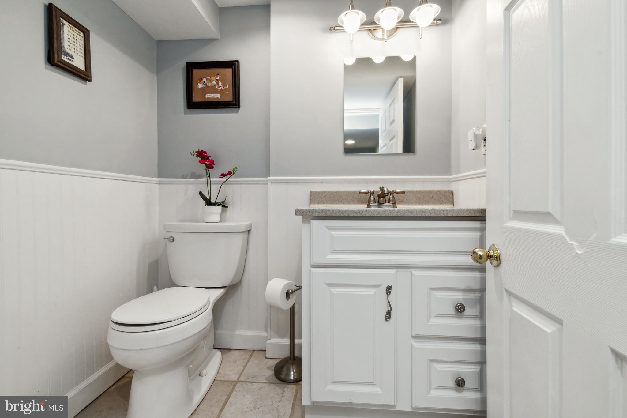 511 Wilton Road Towson, MD 21286 - Photo 29 of 39 a bathroom with a toilet sink and mirror