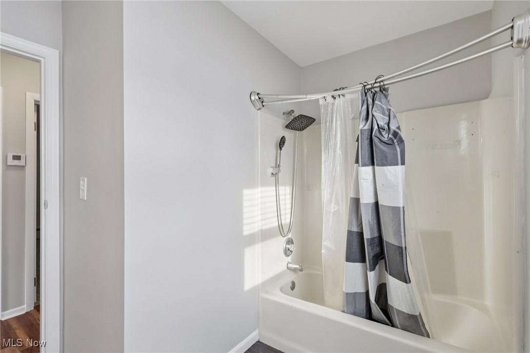 611 Wilson Street Struthers, OH 44471 - Photo 33 of 44 Bathroom with shower / bath combo with shower curtain and baseboards