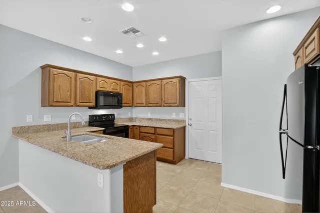 a kitchen with granite countertop appliances cabinets and a counter top space