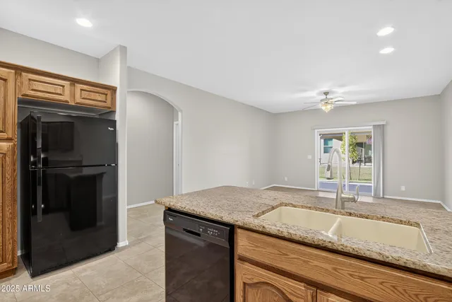 a kitchen with granite countertop a sink and a stove