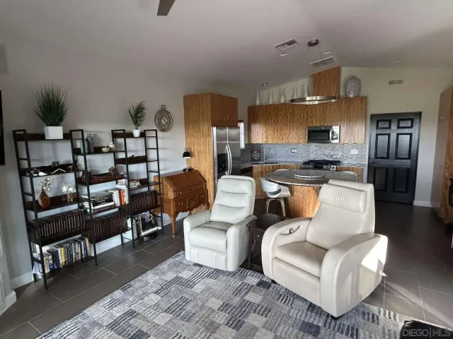 a living room with furniture and a kitchen view
