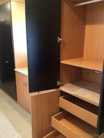 a bedroom with a large bed and dresser