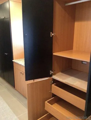 a bedroom with a large bed and dresser