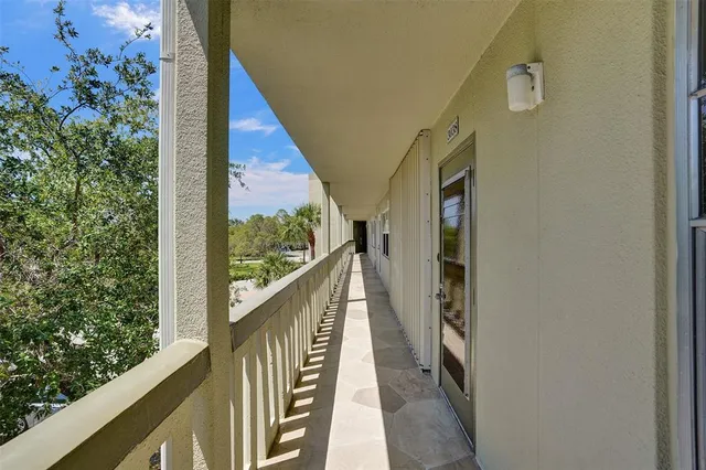 a view of balcony with wooden floor and fence