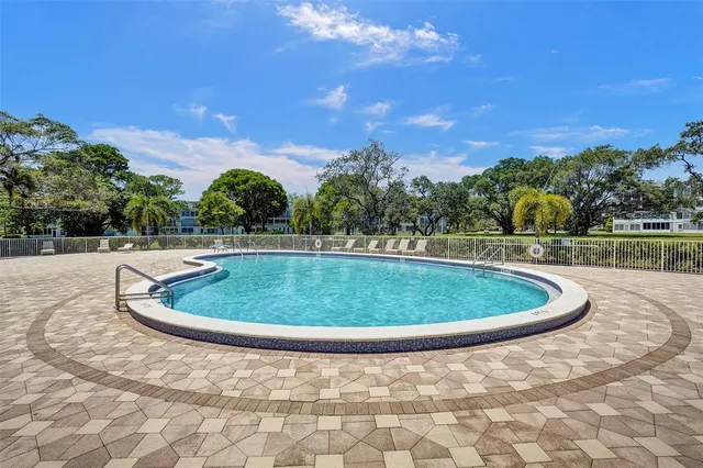 a view of a swimming pool and trees in the background